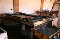 The pulp is then pressed flat to squeeze out the water