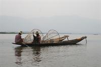 Fishermen on their boats with their nets