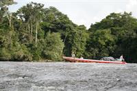 The boat heading towards a small rapid