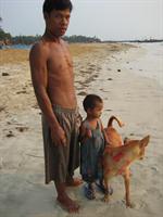 A fisherman with his daughter and dog on Ngapali Beach